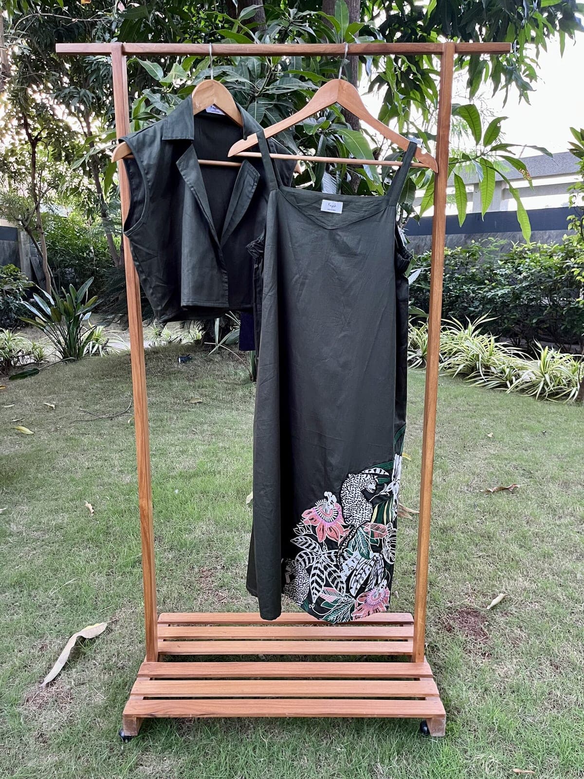 Dark green version on the same rail, thin straps and a soft sweetheart neck, jungle embroidery in white, green and pink at the hem.